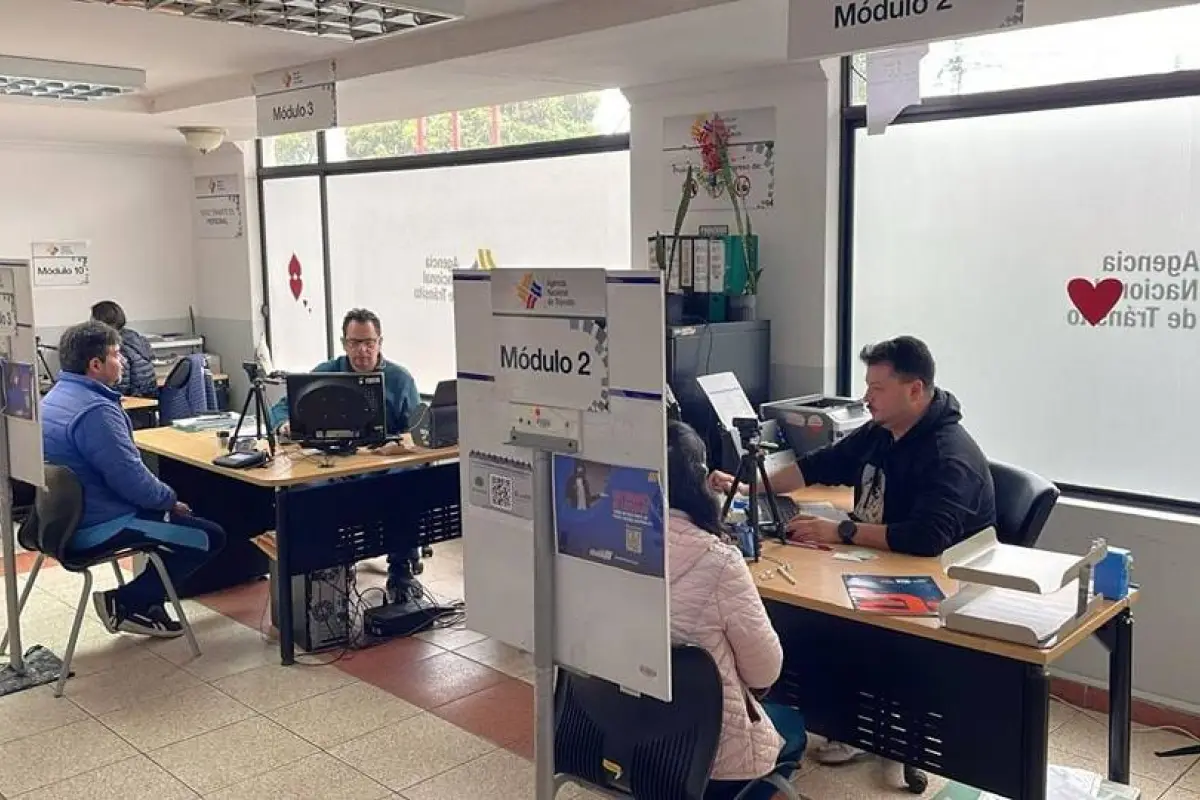 Ciudadanos en oficinas de la ANT Ecuador realizando trámites de licencias y matriculación sin bloqueos por multas.