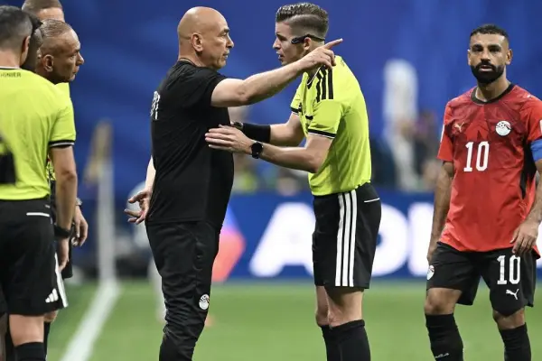 El seleccionador de Egipto, Hossam Hassan, habla con el árbitro francés François Letexier durante el partido contra Argentina. 